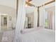 Bright primary bedroom featuring a four post bed, neutral carpet, soft colors, and vaulted ceilings at 6622 W Dickens Xing, McCordsville, IN 46055