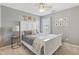 Inviting bedroom featuring a large bed, soft carpet, a ceiling fan, and comic-themed wall art at 6622 W Dickens Xing, McCordsville, IN 46055