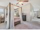 Stylish primary bedroom featuring a four post bed, neutral carpet and vaulted ceilings at 6622 W Dickens Xing, McCordsville, IN 46055