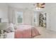 Cozy bedroom with two windows, a ceiling fan, a pink bedspread and white walls at 6622 W Dickens Xing, McCordsville, IN 46055