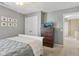 Bedroom featuring a large dresser, a TV, neutral walls, soft carpet, and comic-themed wall art at 6622 W Dickens Xing, McCordsville, IN 46055