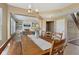 Open-concept dining room featuring living room and staircase at 6622 W Dickens Xing, McCordsville, IN 46055