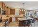Open kitchen with granite countertops, stainless appliances, and an adjacent dining area at 6622 W Dickens Xing, McCordsville, IN 46055