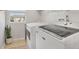 Functional laundry room with modern appliances and a window, creating a bright and efficient space at 6622 W Dickens Xing, McCordsville, IN 46055