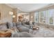 Inviting living room with a plush sectional sofa, stylish decor, and open layout leading to the dining area at 6622 W Dickens Xing, McCordsville, IN 46055