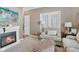 Cozy living room with fireplace, comfortable seating, and charming french doors offering natural light at 6622 W Dickens Xing, McCordsville, IN 46055