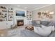 Cozy living room with a fireplace, built-in bookshelves, comfortable seating, and stylish decor at 6622 W Dickens Xing, McCordsville, IN 46055