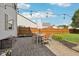 Outdoor patio with a dining table set surrounded by a lush green lawn and wood fence at 6622 W Dickens Xing, McCordsville, IN 46055