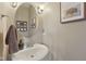 Powder room featuring a pedestal sink, round mirror, and neutral wall color at 6622 W Dickens Xing, McCordsville, IN 46055
