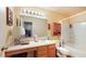 Well-lit bathroom with laminate countertop, tile flooring, a vanity with storage, and shower-tub combo at 6816 Minnow Dr, Indianapolis, IN 46237