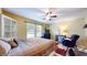Bright bedroom featuring large windows, cozy bed with warm bedding, and a ceiling fan for added comfort at 6816 Minnow Dr, Indianapolis, IN 46237
