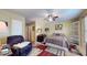 Comfortable bedroom featuring carpet floors, ceiling fan, and a cozy bed with an accent chair and decor at 6816 Minnow Dr, Indianapolis, IN 46237