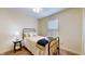 A cozy bedroom featuring a single bed, soft carpet, a ceiling fan and lots of natural light at 6816 Minnow Dr, Indianapolis, IN 46237