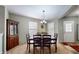 Inviting dining area with stylish light fixture, hutch, and natural light at 6816 Minnow Dr, Indianapolis, IN 46237