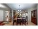 Inviting dining area with stylish light fixture and view into Gathering room at 6816 Minnow Dr, Indianapolis, IN 46237