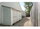 Side view of a garage with large doors, set along a gravel path and wooden fence at 6816 Minnow Dr, Indianapolis, IN 46237