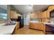 Spacious kitchen offering wood cabinetry, black appliances, laminate countertop, and durable flooring at 6816 Minnow Dr, Indianapolis, IN 46237