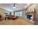 Spacious living room with a fireplace, vaulted ceilings, and access to the dining area at 6816 Minnow Dr, Indianapolis, IN 46237