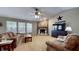 Cozy living room with a fireplace, vaulted ceilings, and abundant natural light at 6816 Minnow Dr, Indianapolis, IN 46237