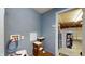 Functional mud room area featuring blue walls, a cat tree, and access to the garage at 6816 Minnow Dr, Indianapolis, IN 46237