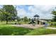 Community playground featuring a slide, swings, and climbing structures, perfect for Gathering fun and outdoor activities at 6816 Minnow Dr, Indianapolis, IN 46237