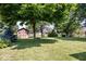 The spacious backyard features mature trees, green grass, and a storage shed at 770 Viewpoint Dr, Plainfield, IN 46168
