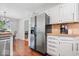 Kitchen area with stainless steel appliances, white cabinets, and adjacent dining space at 770 Viewpoint Dr, Plainfield, IN 46168