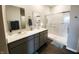 Modern bathroom featuring double sinks, a large shower, and a white and gray design at 7808 Grande Oaks Dr, Plainfield, IN 46168