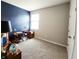 Bedroom featuring a deep blue accent wall and natural light from a window, offering a calming atmosphere at 7808 Grande Oaks Dr, Plainfield, IN 46168