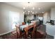Dining area with an ornate chandelier, a view of the open-concept kitchen, and a patio door at 7808 Grande Oaks Dr, Plainfield, IN 46168