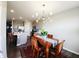 Dining area open to the kitchen features modern chandelier and stylish decor at 7808 Grande Oaks Dr, Plainfield, IN 46168
