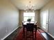 Dining room with a modern chandelier, wooden table, and a view of the backyard at 7808 Grande Oaks Dr, Plainfield, IN 46168