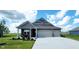 Beautiful single-story home with a landscaped yard and a three-car attached garage at 7808 Grande Oaks Dr, Plainfield, IN 46168