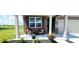 Charming front porch with brick accents, decorated with plants and patio furniture at 7808 Grande Oaks Dr, Plainfield, IN 46168
