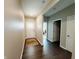 Clean, bright hallway with dark hardwood flooring and neutral wall paint at 7808 Grande Oaks Dr, Plainfield, IN 46168