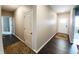 Hallway with hardwood floors and white doors, leading to various rooms in the home at 7808 Grande Oaks Dr, Plainfield, IN 46168