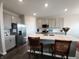 Modern kitchen featuring an island with seating, stainless steel appliances, and sleek countertops at 7808 Grande Oaks Dr, Plainfield, IN 46168