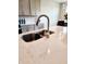 Modern kitchen sink and countertop space with stylish faucet and bright lighting at 7808 Grande Oaks Dr, Plainfield, IN 46168