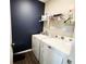Efficient laundry room with a modern washer and dryer, plus ample shelving for storage at 7808 Grande Oaks Dr, Plainfield, IN 46168
