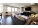 Inviting living room with hardwood floors, a plush couch, and a large flat screen television at 7808 Grande Oaks Dr, Plainfield, IN 46168