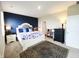 A cozy bedroom with blue accent wall, a bed, and a decorative area rug at 7808 Grande Oaks Dr, Plainfield, IN 46168