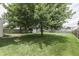 A view of the backyard showing mature trees and green grass at 7914 Willow Wind Cir, Indianapolis, IN 46239