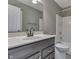 Bathroom features vanity, mirror, and shower-tub combo with white tiling at 7914 Willow Wind Cir, Indianapolis, IN 46239