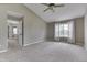 Large primary bedroom featuring a ceiling fan, carpeted floor, and large bright window at 7914 Willow Wind Cir, Indianapolis, IN 46239
