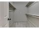 Walk-in closet with neutral carpet and bright white shelving, ready for plenty of storage at 7914 Willow Wind Cir, Indianapolis, IN 46239