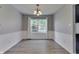 Bright dining room featuring modern flooring, wainscoting, and a classic chandelier at 7914 Willow Wind Cir, Indianapolis, IN 46239