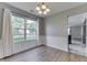 Bright dining room features wainscoting, wood floors, and a window overlooking the backyard at 7914 Willow Wind Cir, Indianapolis, IN 46239