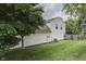 Side view of the home featuring mature landscaping, green lawn, and ample space at 7914 Willow Wind Cir, Indianapolis, IN 46239