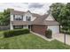 Charming two-story home featuring a brick-accented facade, attached garage, and well-manicured lawn at 7914 Willow Wind Cir, Indianapolis, IN 46239