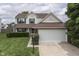 Two-story home with green shutters, well-manicured lawn and an attached two car garage at 7914 Willow Wind Cir, Indianapolis, IN 46239